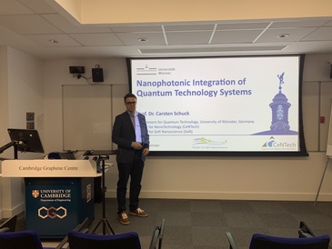 Prof. Carsten Schuck standing in front of his presentation title slide