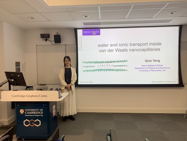 Lady standing in front of her presentation title slide.
