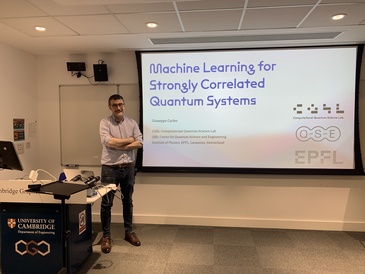 Man standing in front of a lecture screen next to a lectern.