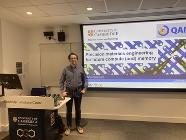 Man standing in front of a lecture screen next to a lectern.