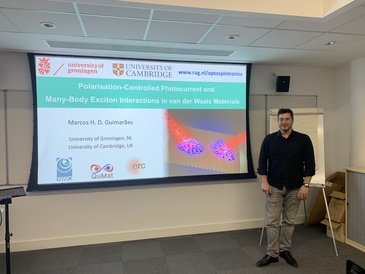 Man standing in front of a lecture screen next to a lectern.
