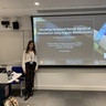 Professor Amparo Guemes Gonzalez standing in front of her title slide